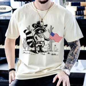 Funny Western Cowboy 4th of July T-Shirt – USA Raccoon Graphic Tee, Patriotic Independence Day T-Shirt with American Flag and 1776 Design