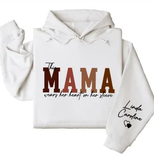 Custom This Mama Wears Her Heart On Her Sleeve Hoodie – Personalized Mom Shirt, Mother’s Day Gift for New Moms